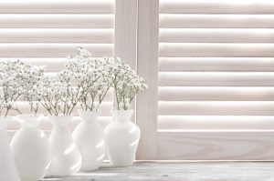 White shutters with small vases in front, Shutters & Blinds of Arizona, Phoenix AZ